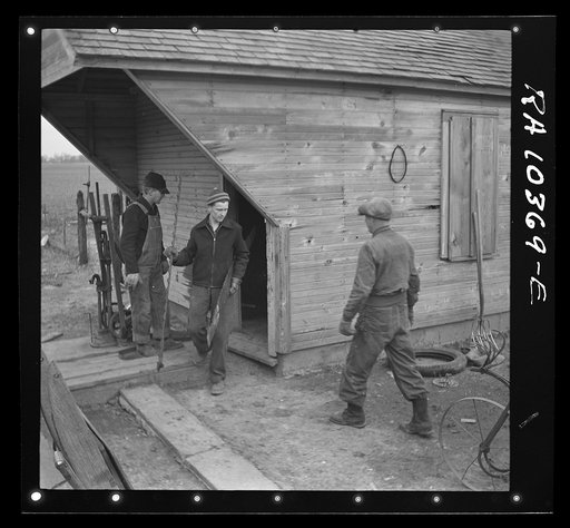 Removing tools from shed during moving operations of Everett Shoemaker, tenant farmer. Near Shadeland Indiana