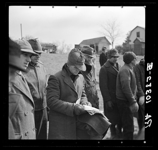 The clerk at the closing-out sale on Frank Sheroan's farm makes a note on the sale of equipment. Near Montmorenci, Indiana
