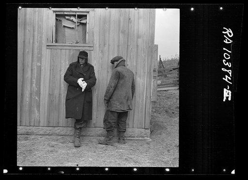 Farmers trying to keep warm at closing-out sale of Frank Sheroan's farm. Near Montmorenci, Indiana