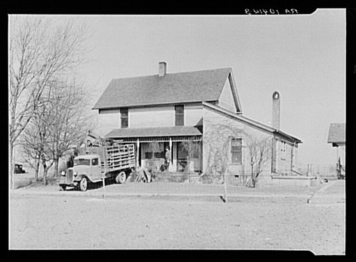 Everett Shoemaker, tenant farmer near Shadeland, Indiana, moving his household goods from the farm