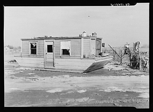 Houseboat washed high and dry amid debris. Maunie, Illinois