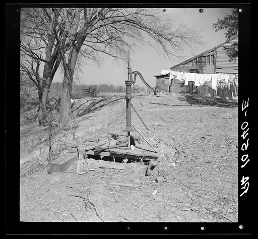 A broken pump on Erasty Emrich's farm near Battle Ground, Indiana. The tenant has to go downhill one hundred yeards from his house for water