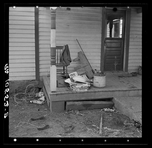 Backporch of Charles Miller's farmhouse during moving operations. Miller, for twelve years a hired farmhand, has now rented a farm to work for himself near Fowler, Indiana