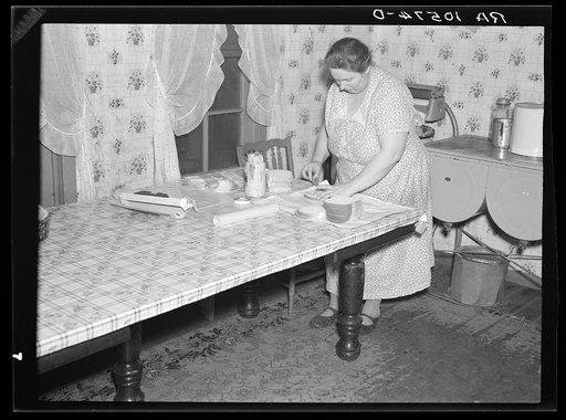 7 a.m. Mrs. Tip Estes, wife of a hired man near Fowler, Indiana, preparing lunches for the five of her nine children who go to school