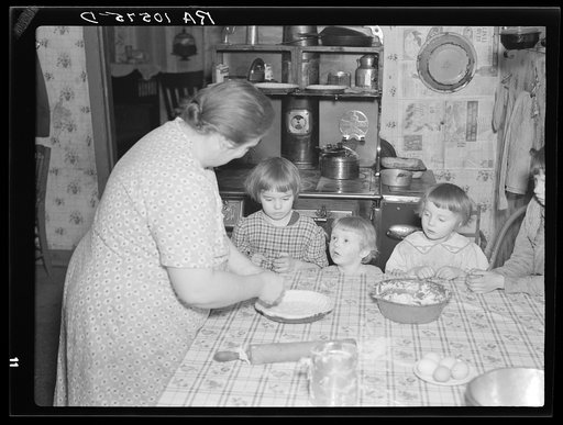 7:45 a.m. Tip Estes' children watch their mother make a pie. Near Fowler, Indiana