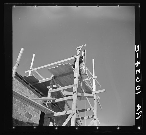 A load of brick going up the building chimney of a house under construction at Greendale, Wisconsin