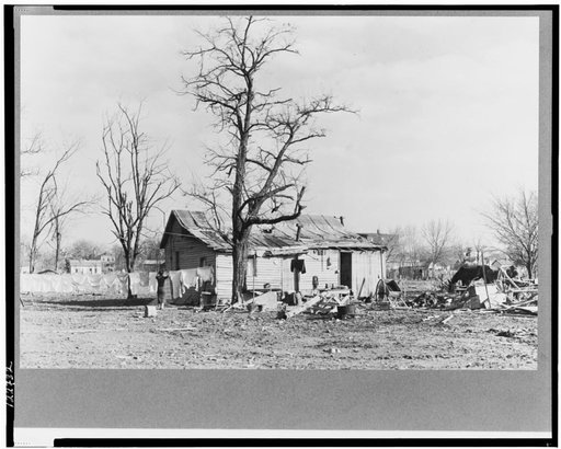 A house devastated by the flood of 1937. Shawneetown, Illinois. The flood subsided, the residents of this house have come back to clean up and live here