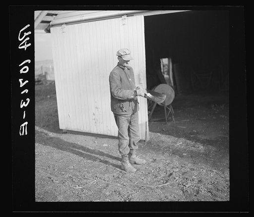 Tip Estes oils the spade before he puts it away. Near Fowler, Indiana