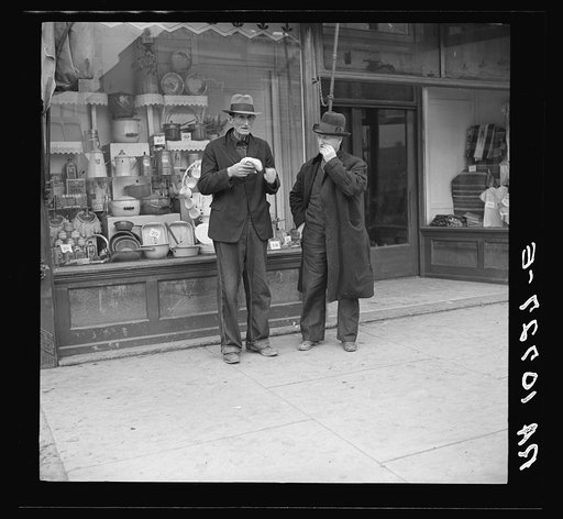 Men in front of grocery and department store. Shawneetown, Illinois