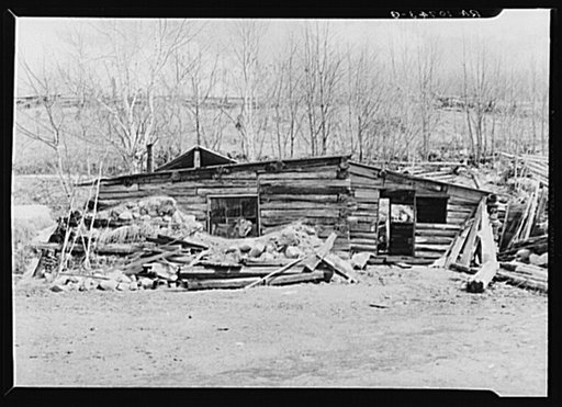 Home of Buckboard Charlie, squatter near Iron River, Michigan. Spring yard cleaning has just taken place