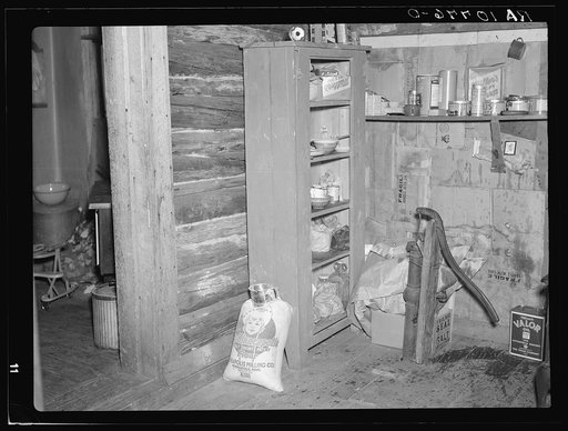 Corner of room occupied by the Smallwoods in a two-family shack near Alvin, Wisconsin. The pump does not work
