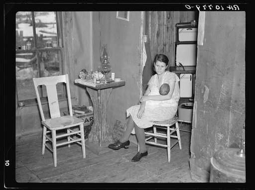 Mrs. Smallwood and her baby in the shack which they share with another family near Alvin, Wisconsin