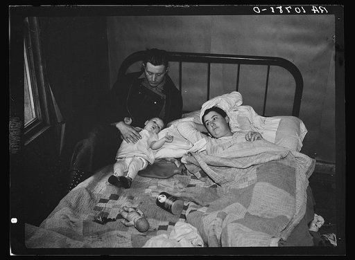 The Ingraham family who share a shack with another family near Alvin, Wisconsin. Mrs. Ingraham is sick in bed