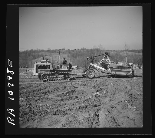 A "le tourneau" in action, drawn by a tractor. Martin County development project. Indiana