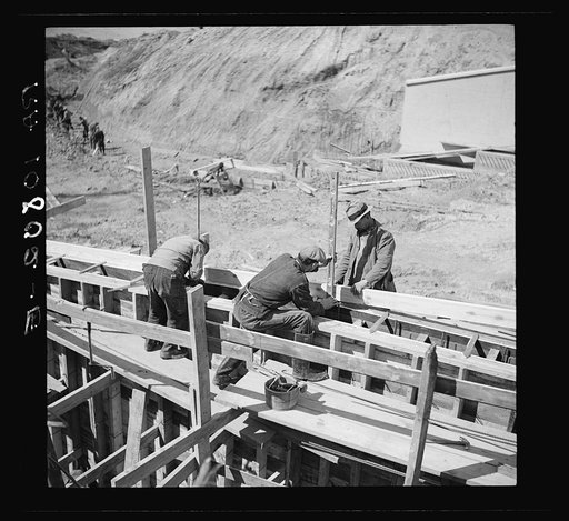 Men working on forms for concrete wall for spillway. Martin Company development project. Indiana