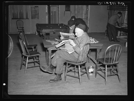Men in the recreation room of the transient camp at Hagerman Lake, Michigan