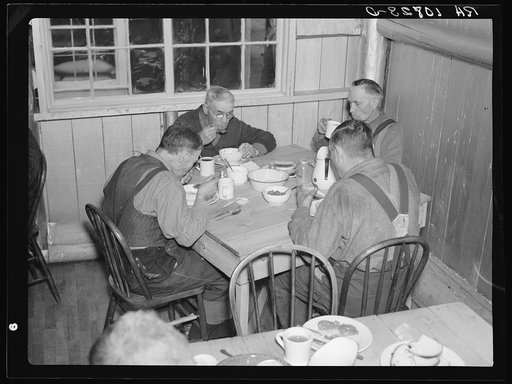 Men eating in the transient camp at Hagerman Lake, Michigan. This is a former lumber camp