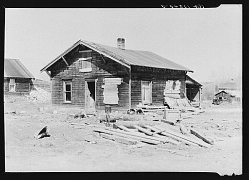 Typical house in Gibbs City, Michigan, a sawmill town. Two families live in this house