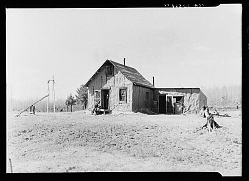 The home of Max Sparks and family near Long Lake, Wisconsin. The family was forced to move from the place they were buying to this shack because of inability to pay three dollars monthly which was the basis of the contract. In moving from one county to another they have jeopardized their qualificati