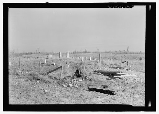 Country graveyard in isolated cut-over forest land near Tipler, Wisconsin. Note fresh grave outside the enclosure