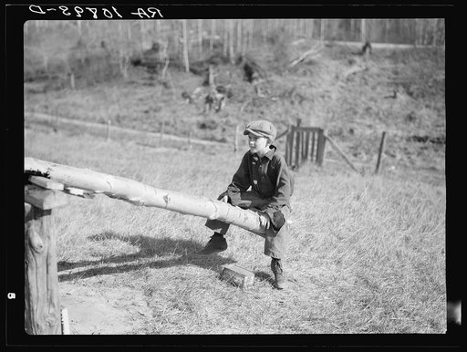 One of the Max Sparks' children playing on homemade teeter-totter near Long Lake, Wisconsin