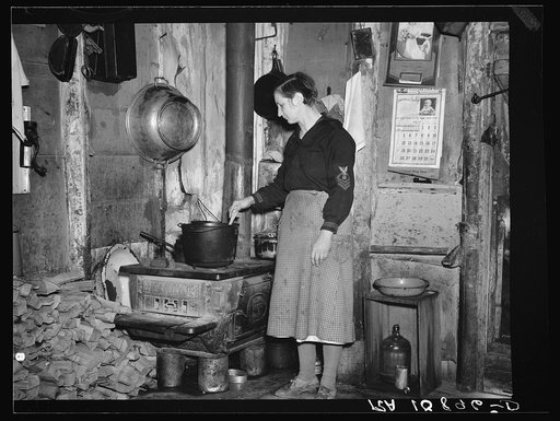 Mrs. Lon Allen stirring the soup in her home near Iron River, Michigan