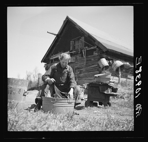 John Bastia doing his washing. He is a single shacker from Iron County, Michigan