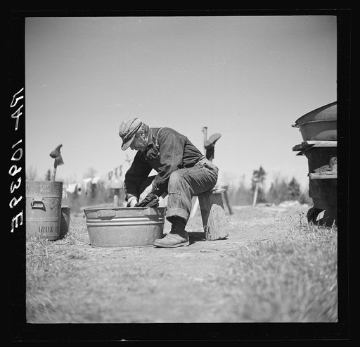 John Bastia doing his washing. He is a single shacker from Iron County, Michigan