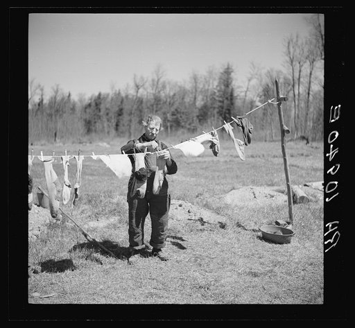 John Bastia hanging up his laundry. He is a single shacker in Iron County, Michigan
