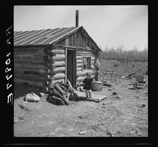 One of the Bodray children in front of the family home near Tipler, Wisconsin