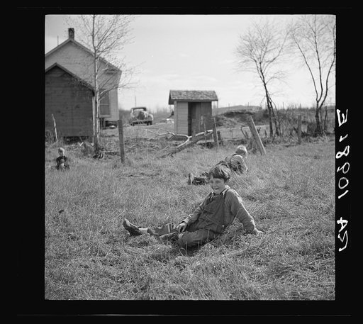 Children resting during recess at a rural school near Tipler, Wisconsin