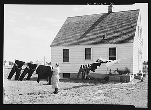 Woman hanging out clothes. Austin Homesteads, Minnesota