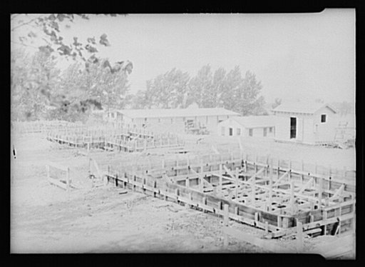 Warehouse and foundations of homes under construction at Resettlement Administration project. Ironwood, Michigan