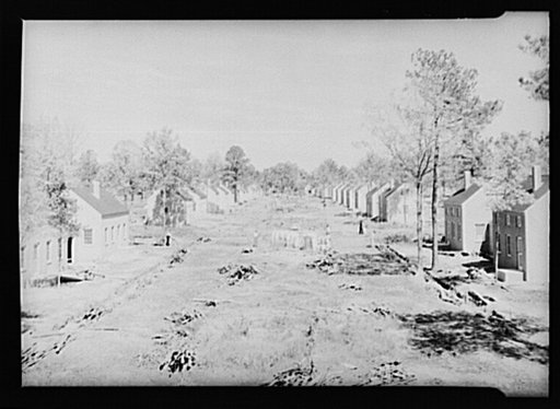 Street lined with partially-completed homes. Newport News Homesteads, Virginia