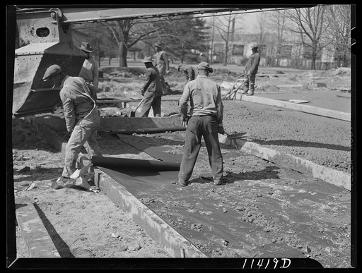 Washington, D.C. Construction of a bridge and road near Independence Avenue and 14th and 16th Streets, S.W. Waterproof paper is placed on a prepared subgrade before pouring the concrete to prevent the water in the mixture from being soaked up by the soil. The water stays in the concrete, making it s