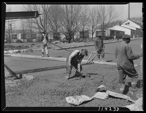 Washington, D.C. Construction of a bridge and road near Independence Avenue and 14th and 16th Streets, S.W. The man in the foreground is shoveling concrete into a low spot