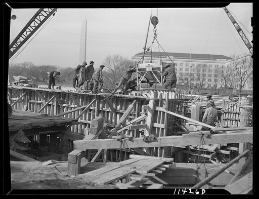 Washington, D.C. Construction of a bridge and road near Independence Avenue and 14th and 16th Streets, S.W. Concrete being poured from a hopper into forms