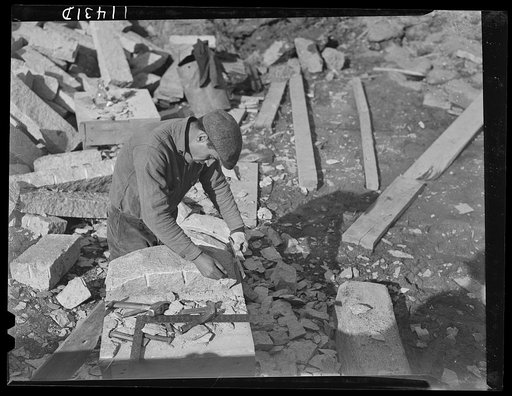 Washington, D.C. Construction of a bridge and road near Independence Avenue and 14th and 16th Streets, S.W. Stone cutter measuring with a ruler