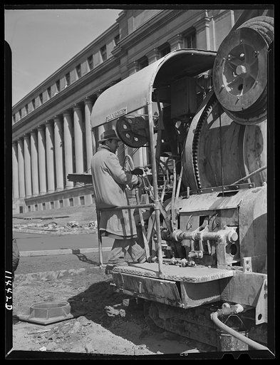 Washington, D.C. Construction of temporary war emergency buildings on the Mall, near 16th and 17th Streets, N.W. Operator of a large concrete mixer standing on the control platform