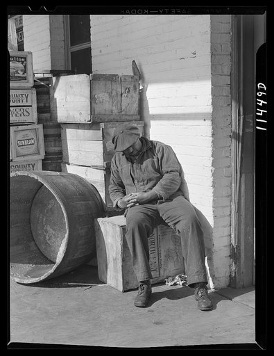 Washington, D.C. Man napping on a box in the fish market