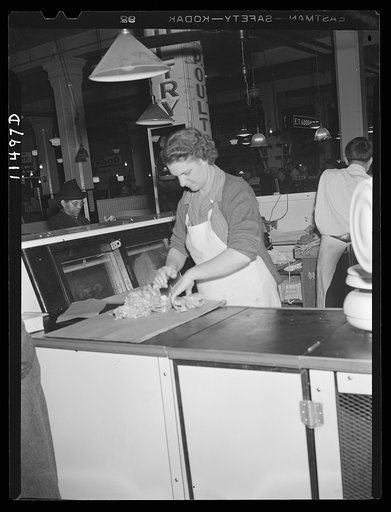 Washington, D.C. Woman wrapping a chicken for a customer in the Arcade Market on 14th Street, N.W.