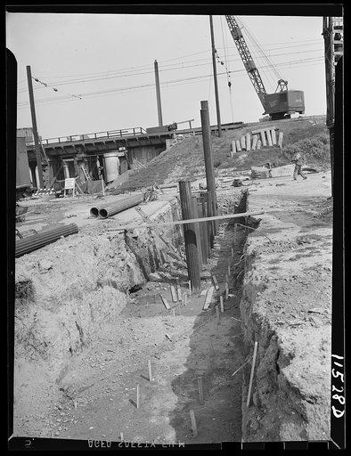 Washington, D.C. Row of piles being driven in a trench. In the foreground are rows of stakes that indicate where other piles are to be driven