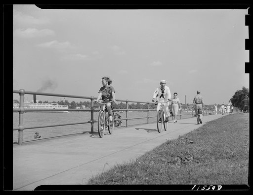 Washington, D.C. Sailor and girl bicycling at Hains Point
