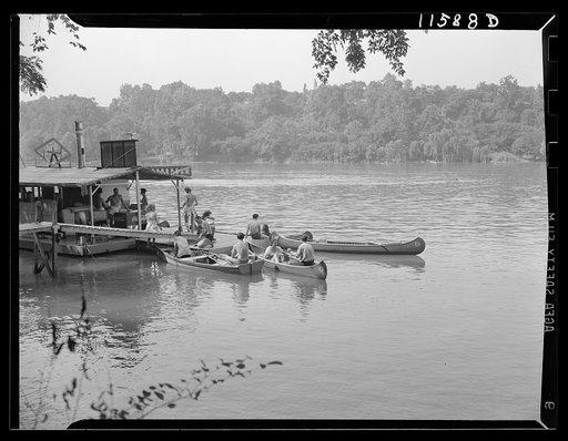 Washington, D.C. (vicinity). Canoes and rowboats tied up at small refreshment barge on the west bank of the Potomac River