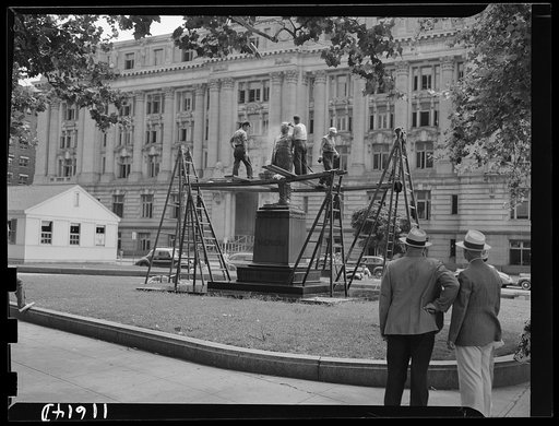 Washington, D.C. Workmen from a monument cleaning company cleaning Shepherd's statue at 14th and E Street, N.W.
