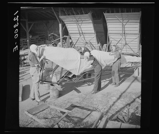 Wives of "duster pilots" recover plane which has been damaged. In this dangerous occupation crashes are common but rarely fatal because of low speed, low altitude and high operating skill. Note farm machinery in background. Seabrook Farms, between Bridgeton and Vineland, New Jersey