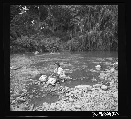 Washing clothes in the river. This is common practice in all rural areas. Puerto Rico