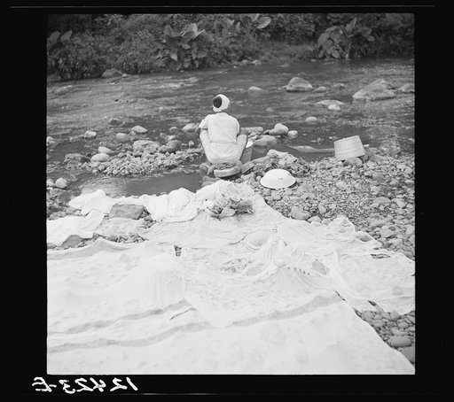 Washing laundry in river in the hill country. Puerto Rico