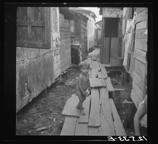 Child in workers' quarter of Puerto De Tierra. San Juan, Puerto Rico