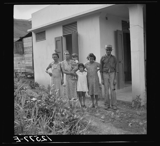 A Puerto Rican family of 5.2. A resettler's family in front of their hurricane-proof house on La Plata project. Puerto Rico